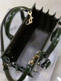 Green patent leather handbag from the Sac De Jour collection